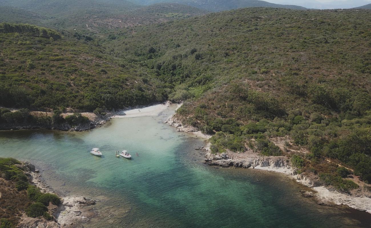 Foto de Malfalcu Cove con arena gris superficie