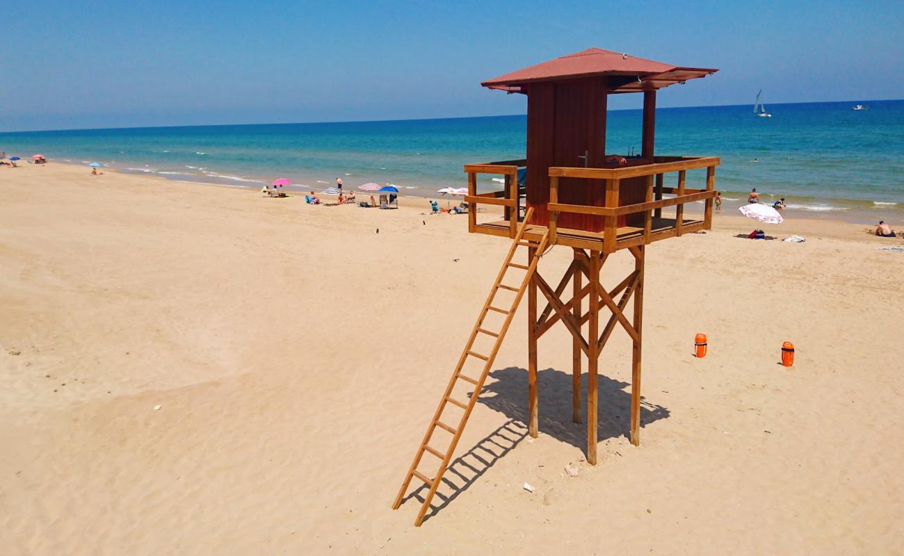 Foto de Cullera Naturista con arena oscura superficie