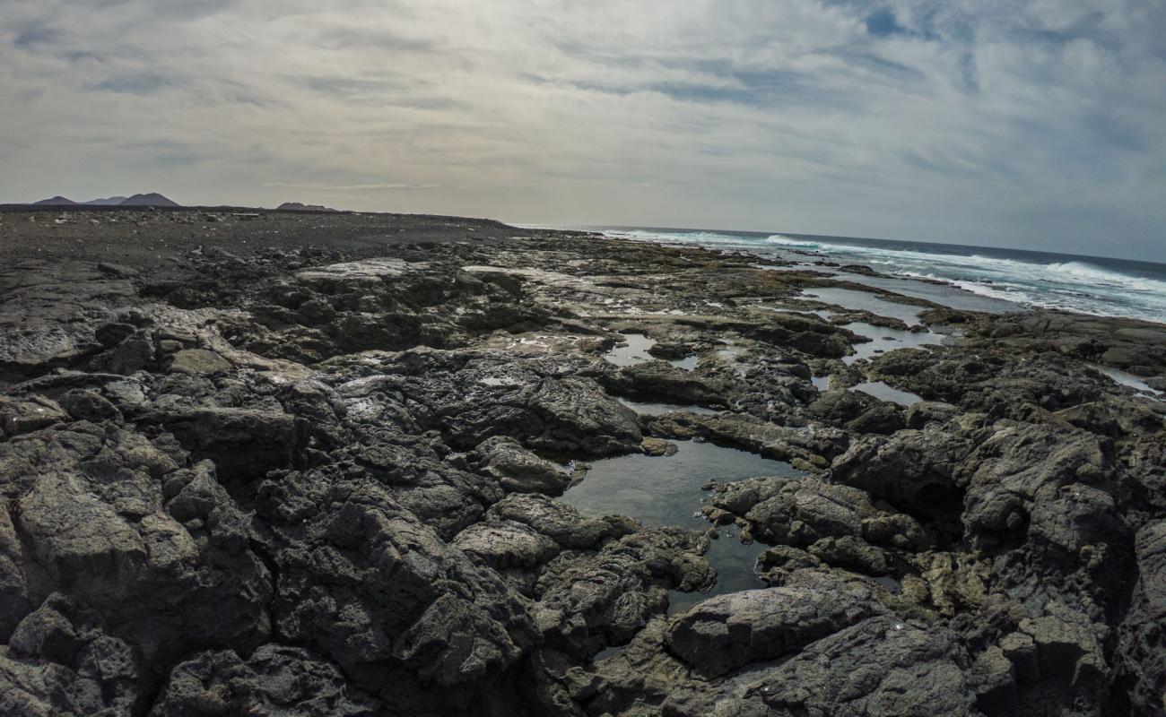 Foto de Playa del Cochino con arena/piedras blanca superficie