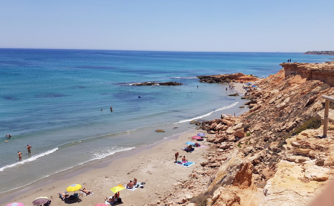 Foto de Cala La Mosca con arena brillante superficie