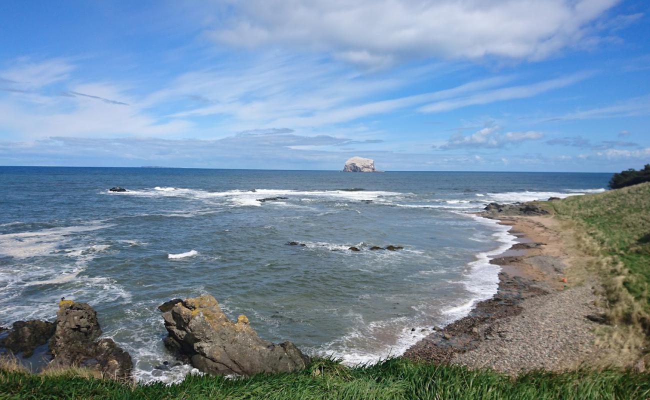 Foto de Haugh Road Beach con arena brillante y rocas superficie